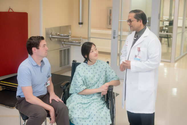 social worker talking to patient and doctor in hospital