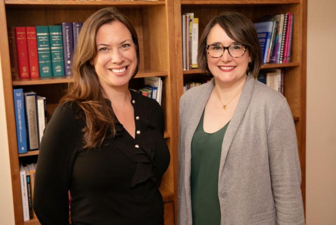 Professors Kate Wegmann Tara Powell standing together in conference room