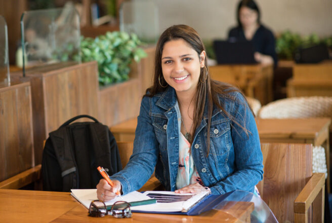 young female student studying in cafe