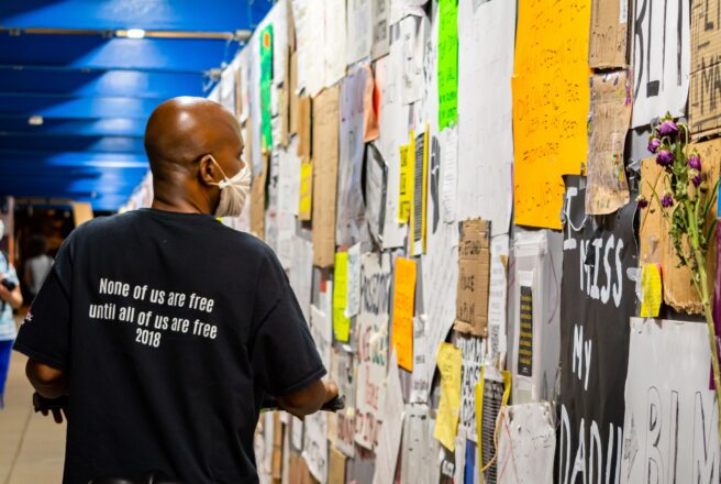 image of man looking at wall fliers