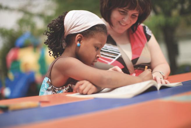 alumna working with child