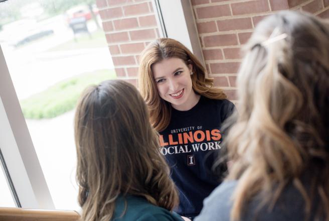 image of student speaking to others near window