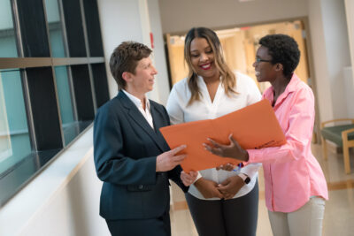 3 people meeting in hospital hallway