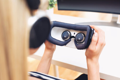 Young woman using virtual reality headset