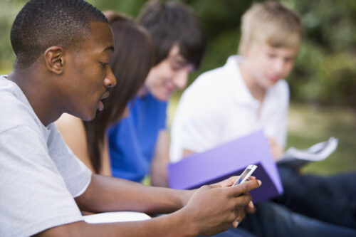 students sitting outside studying together