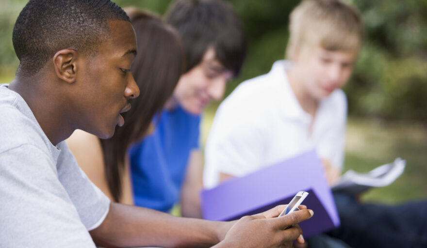 students sitting outside studying together