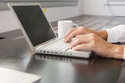 person typing on laptop