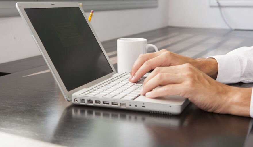 person typing on laptop