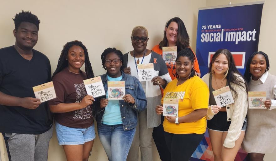 group image of students who are part of The Village Project group standing with Sharva Hampton Campbell