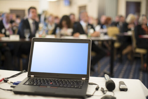 conference table with laptop and mircrophone