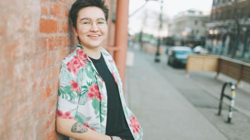 Photo of person leaning on brick wall