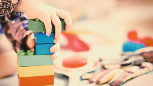 Children's hands playing with blocks