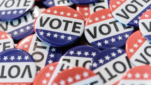 A closeup image of red, white, and blue voting buttons